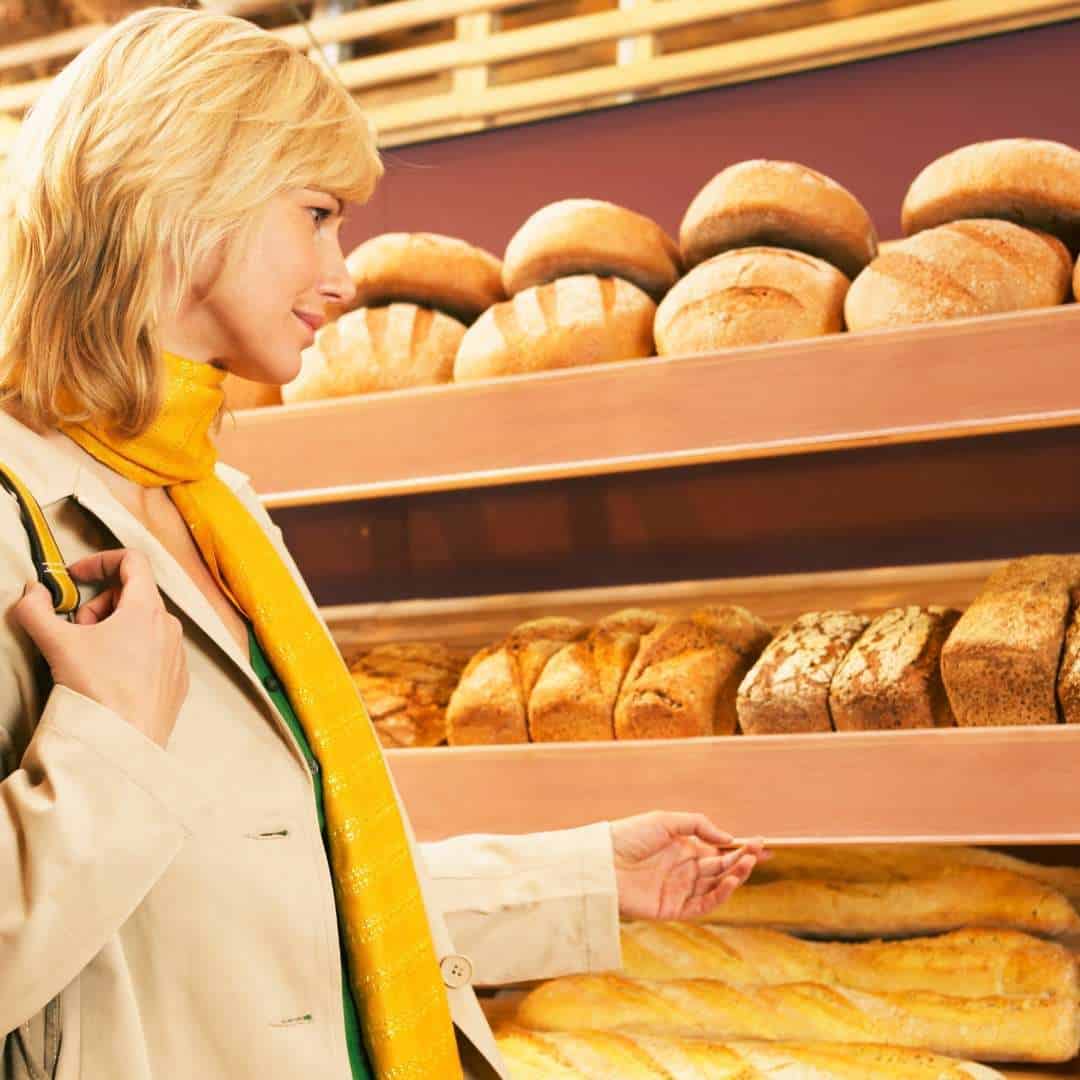 A woman buying bread in the shop