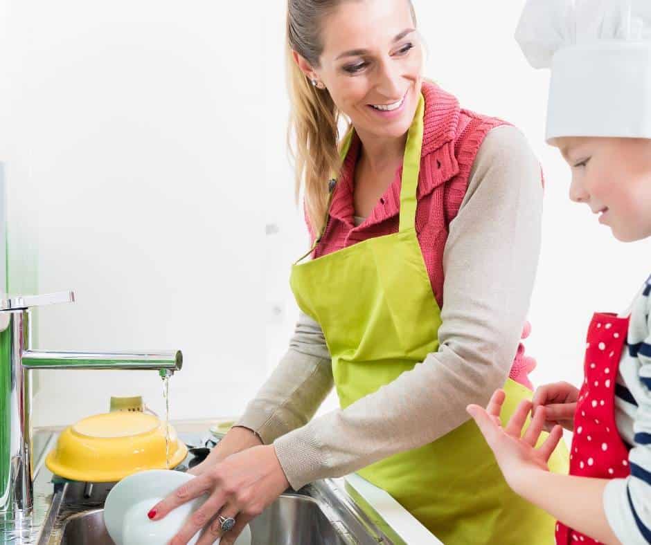 a woman washing dishes