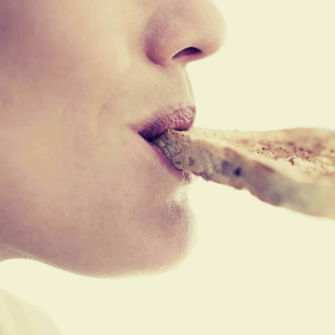 a woman eating a moldy slice