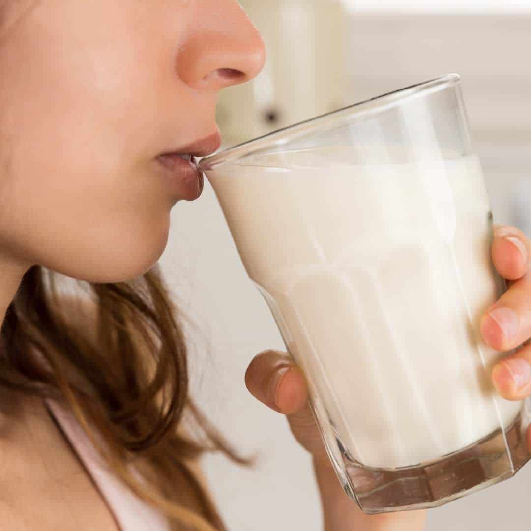 a woman tasting milk