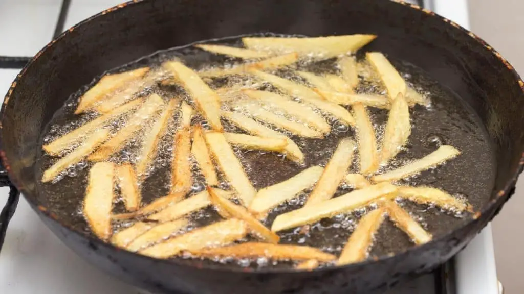cooking fries in a pan