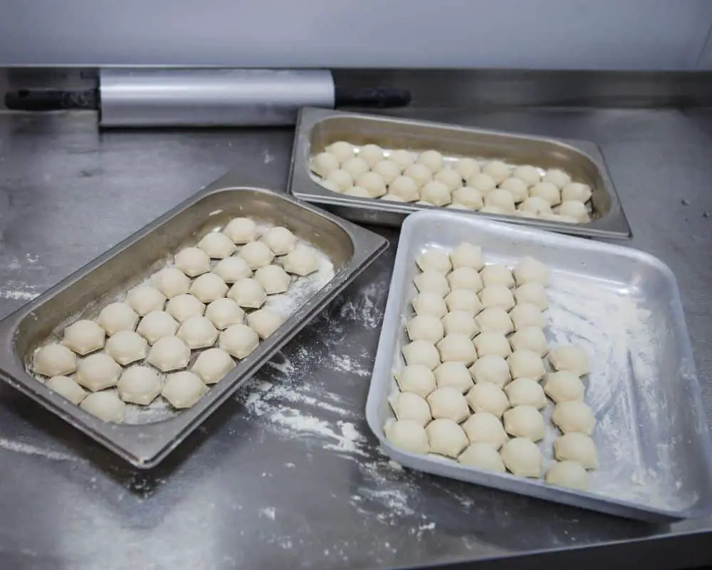 dumplings separated on the baking tray before freezing