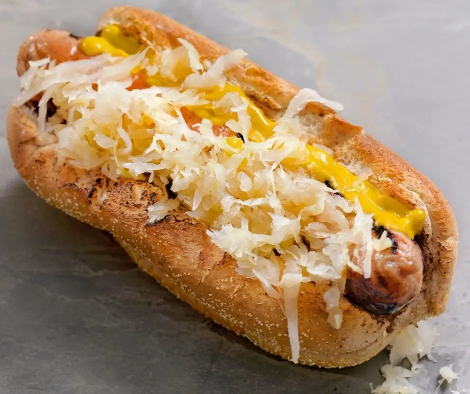 German style hot dog topped with sauerkraut and mustard