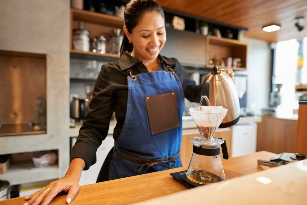 a woman making a fresh brew