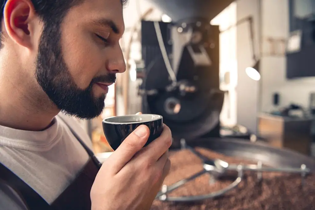 coffee roaster smelling the fresh brew