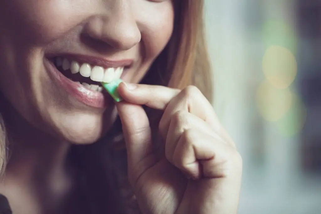 a woman chewing gum