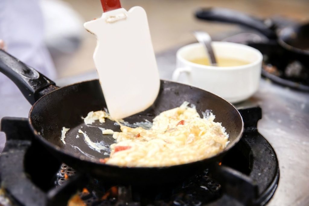 using rubber spatula to make scramble eggs fluffy