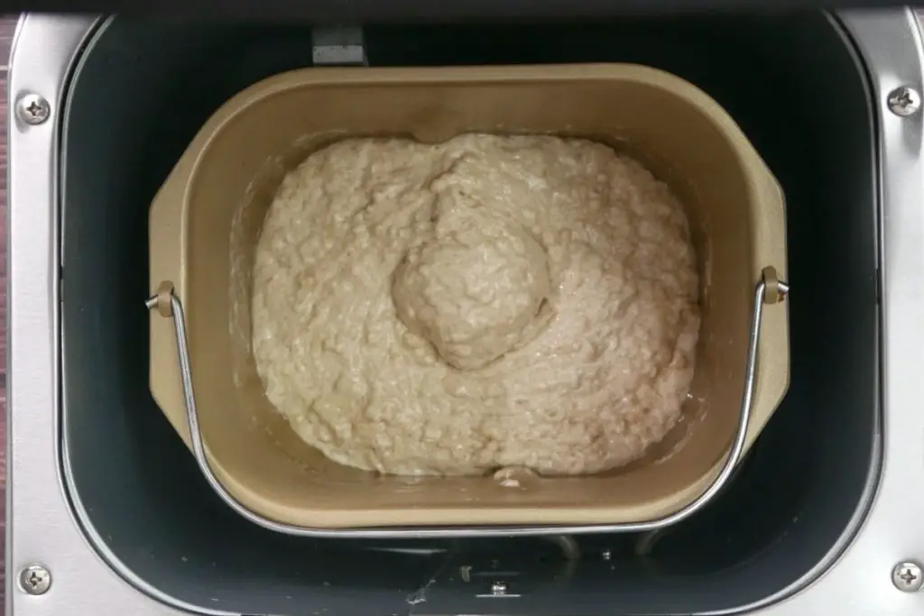 mixing the honey oat dough in the bread maker