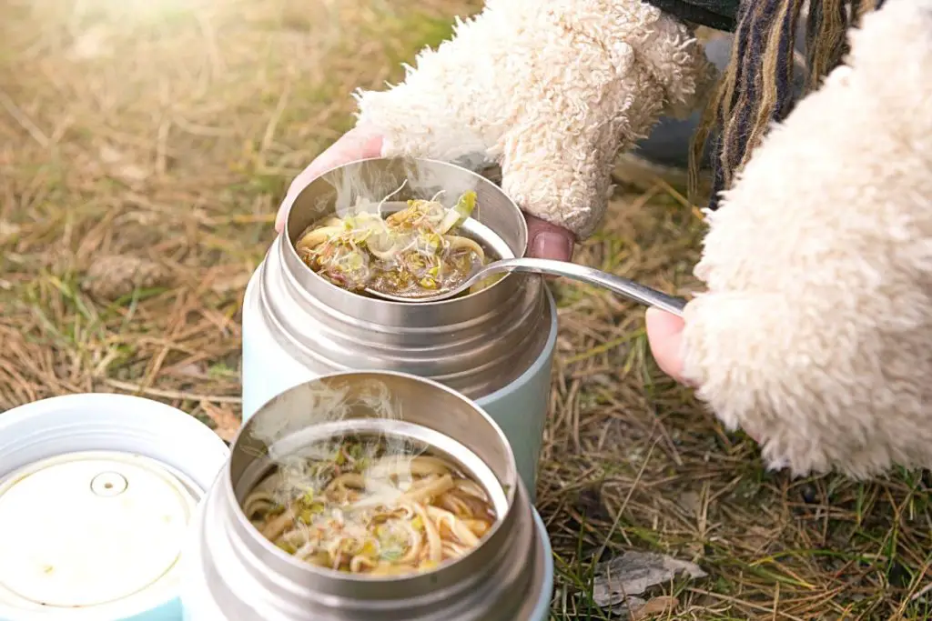 using insulated food flask at camping trip