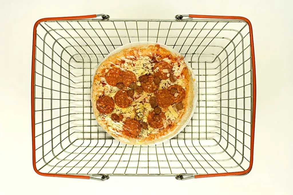 frozen pizza in a shopping basket