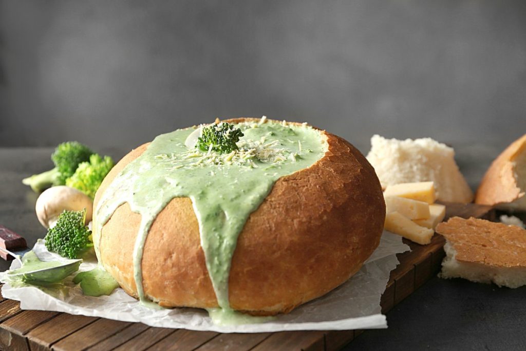 broccoli cheese soup served in a homemade bread bowl