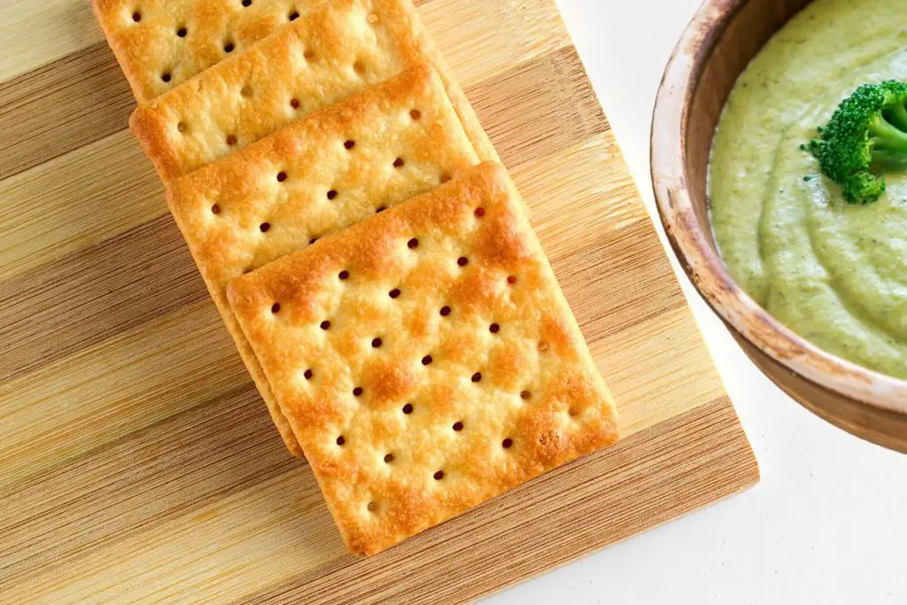 broccoli cheese soup with crackers on side