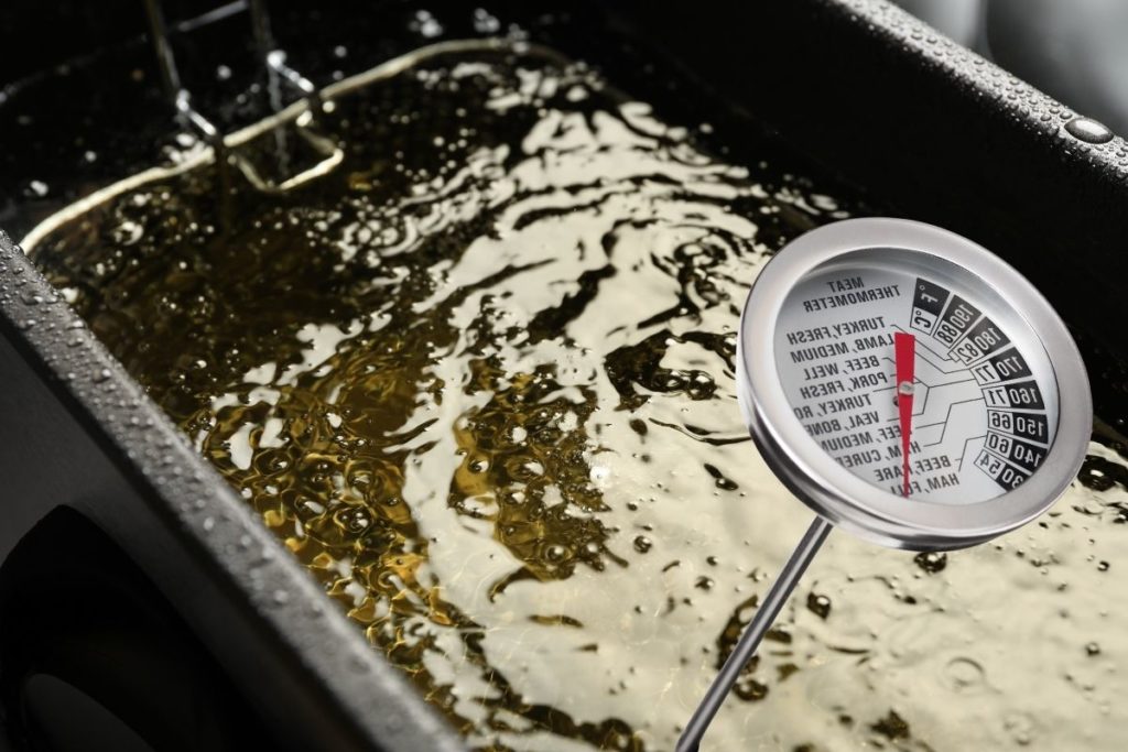 checking the oil temperature with a food thermometer