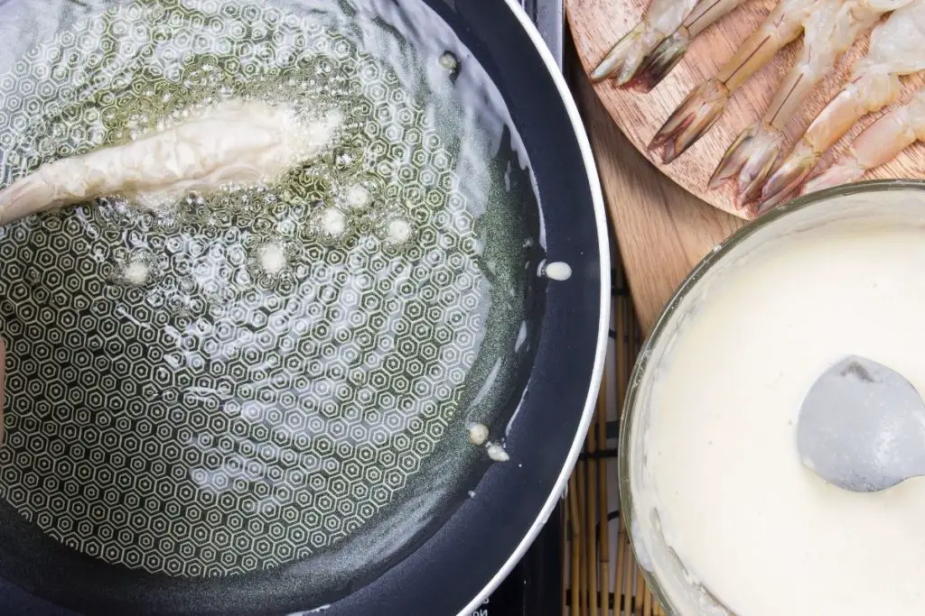 dropping a tiny piece of batter or dough into the oil