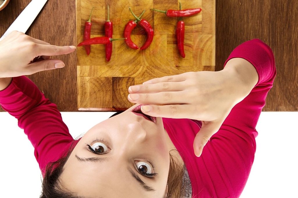 a woman eating hot chilies