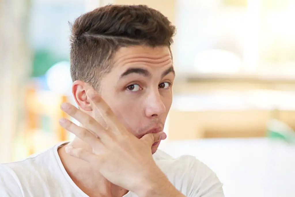 man licking fingers after a meal