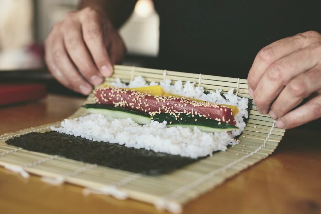 making a sushi roll with tuna fish