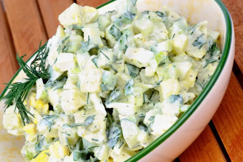 fresh herbs and leafy green in potato salad