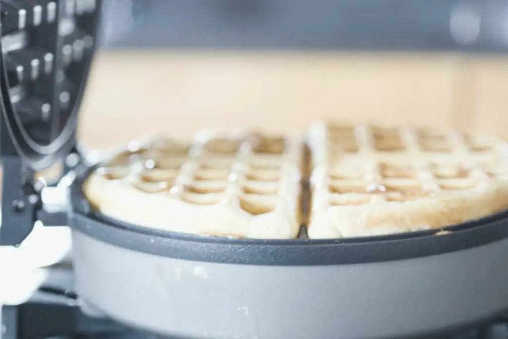 opening the waffle maker while baking