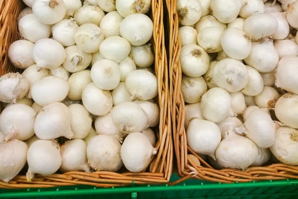 picking white onion at the supermarket