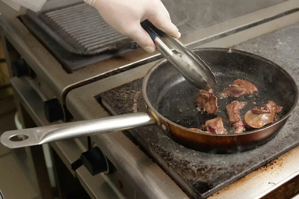 cooking liver in hot skillet pan