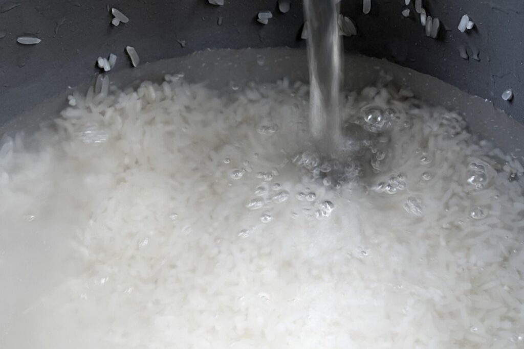 adding water to a rice cooker