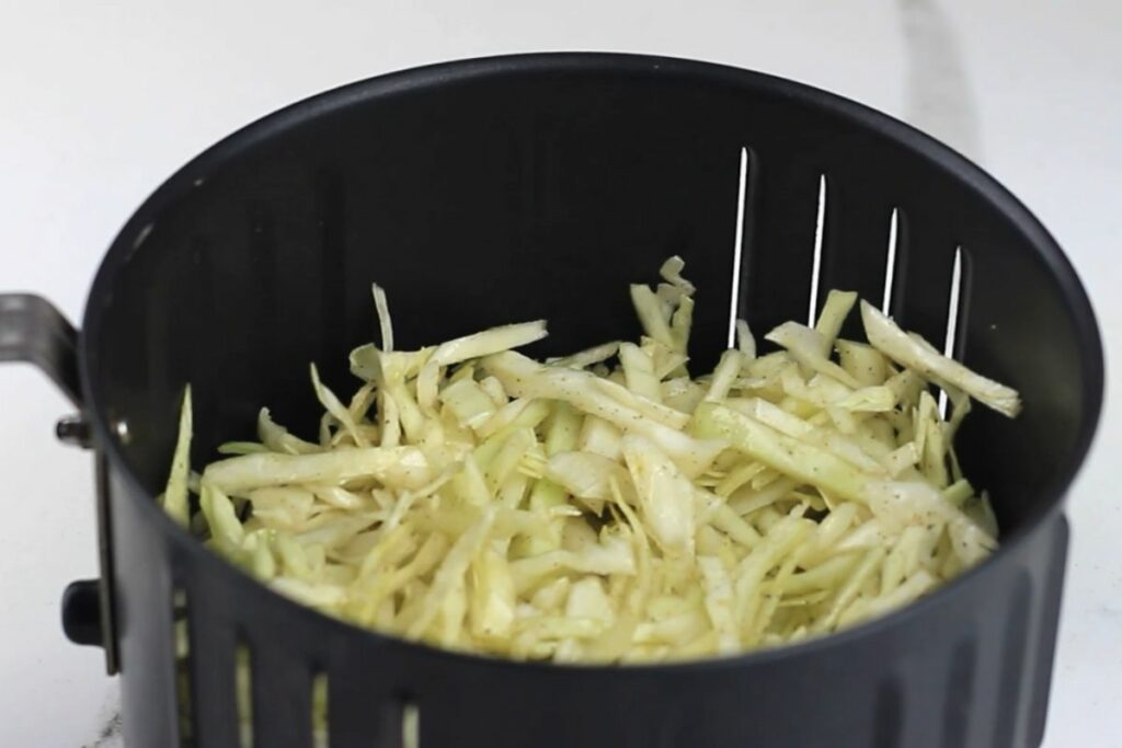shredded cabbage in air fryer basket