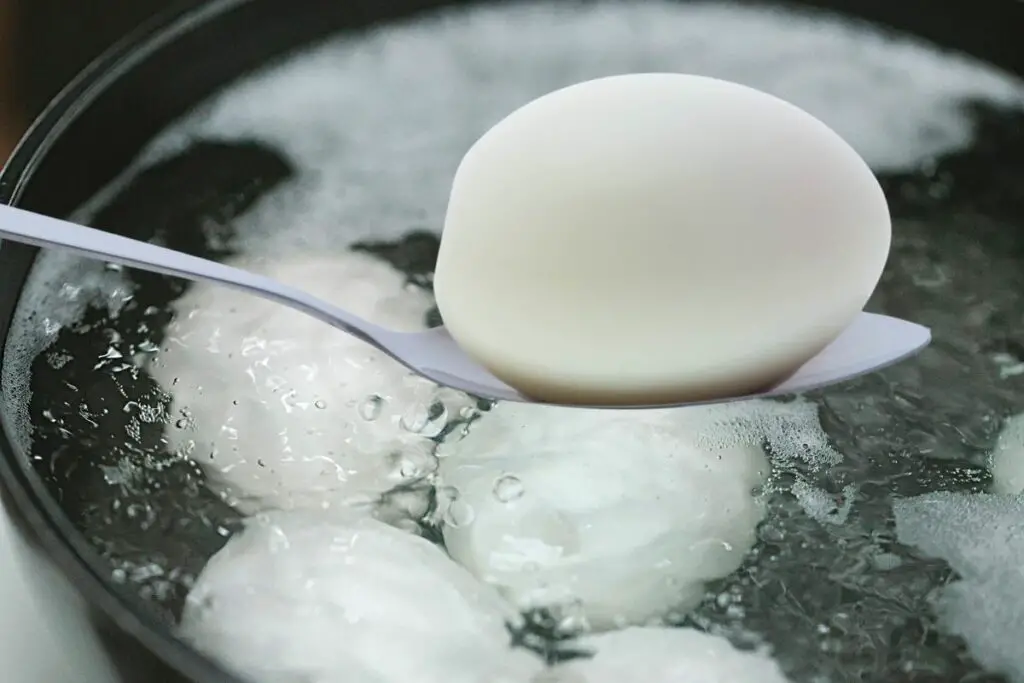 placing the duck eggs in boiling water