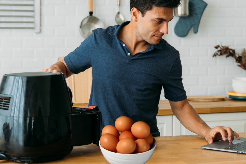 a man seaming for the instruction how to cook hard boiled eggs in an air fryer 