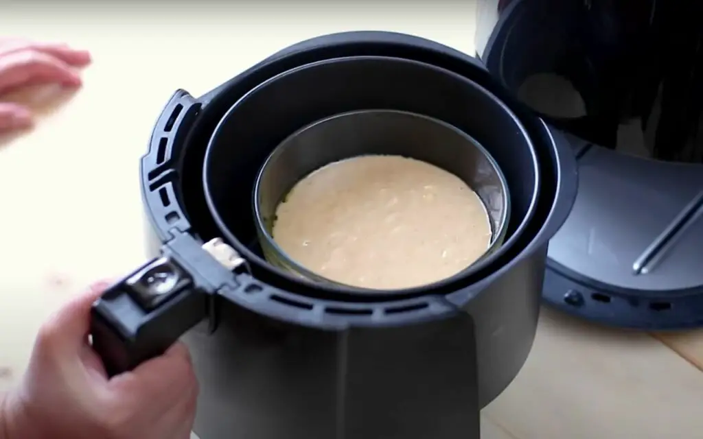 placing banana bread in the air fryer 