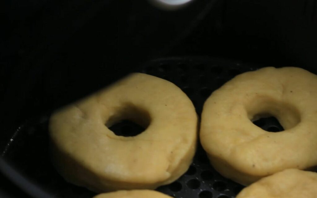 placing the doughnuts in an air fryer basket