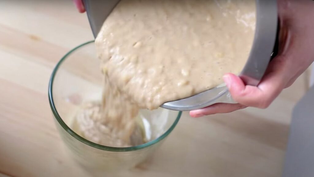 pouring the banana bread batter into the baking dish