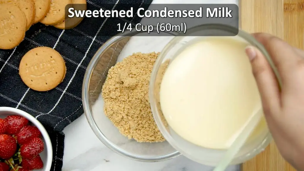 mixing condensed milk and crushed biscuits