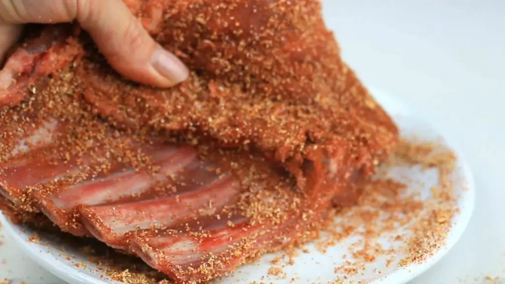 seasoning the ribs with dry rub