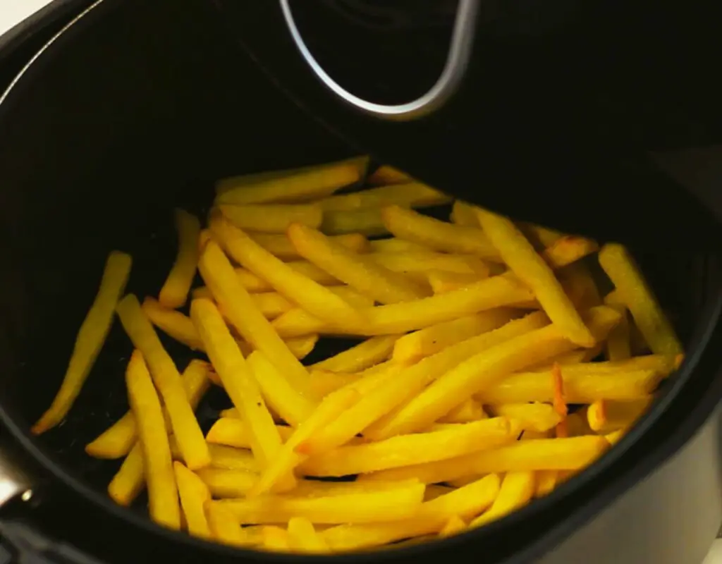 crispy French fries in air fryer basket