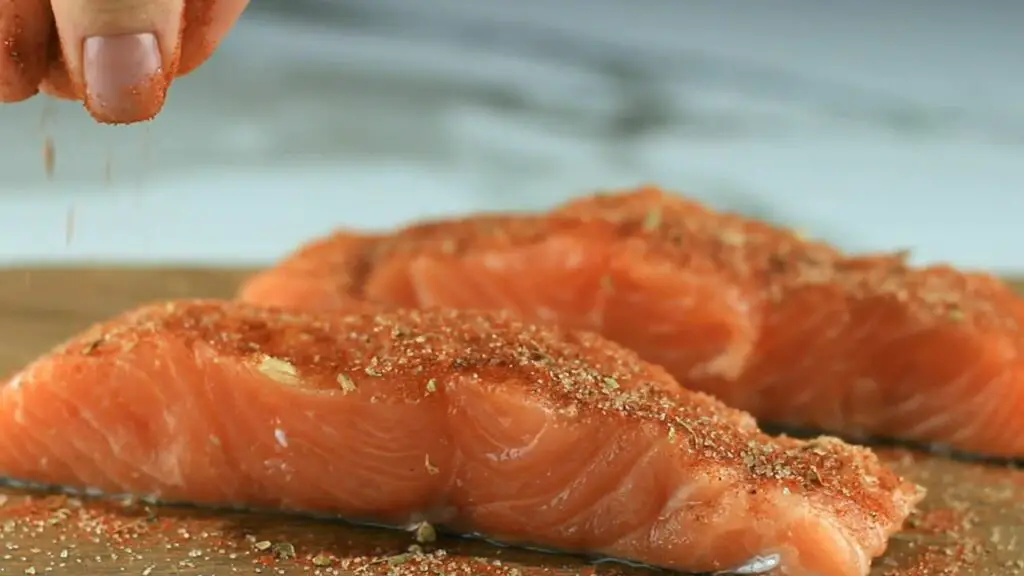 seasoning salmon fillets before cooking in an air fryer 