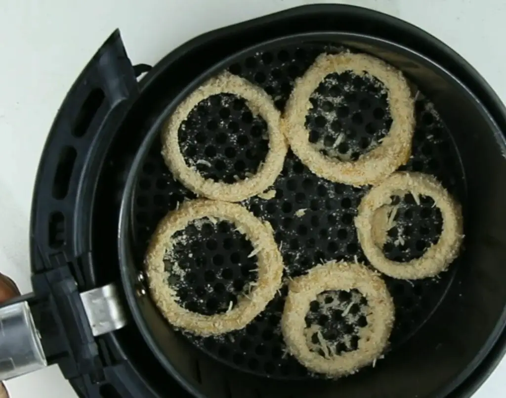 placing the onion rings in air fryer basket