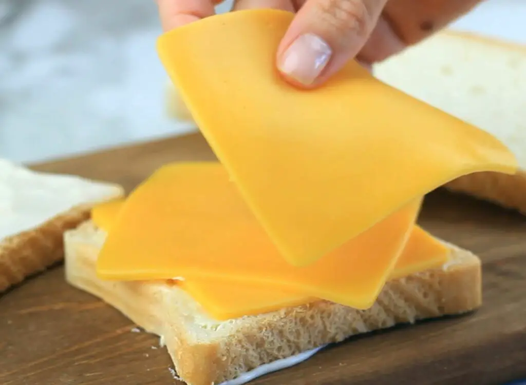 putting the slices of cheese on the bread