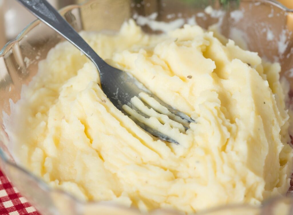 mashing potatoes with a fork