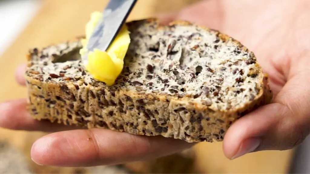 eating flaxseed bread with butter