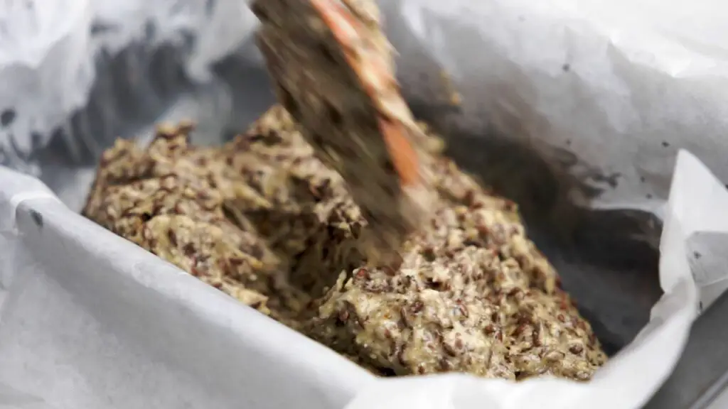 pouring the bread batter into the loaf pan