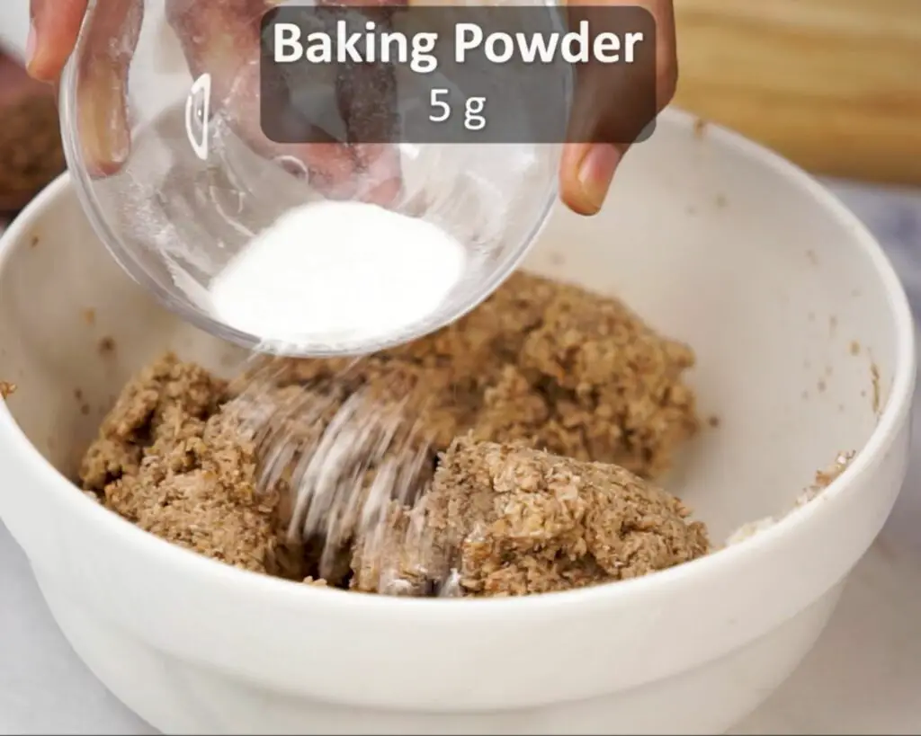 adding baking powder to the bread dough