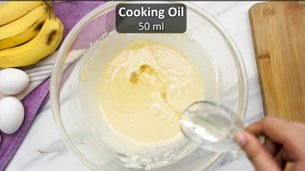 adding oil to the banana cake batter