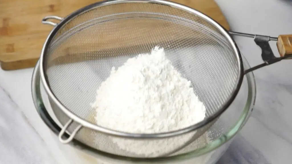 Putting flour through a sifter 