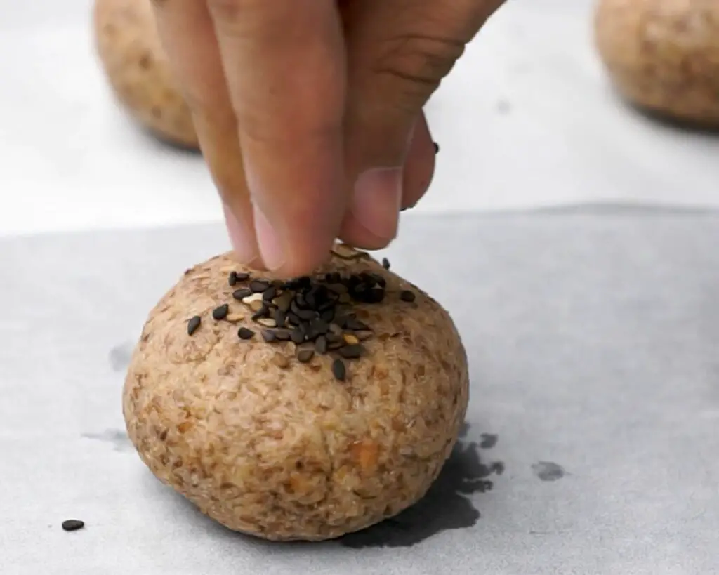 sprinkle some sesame seeds on the bread rolls