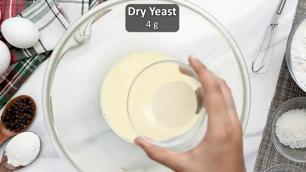Adding the instant dry yeast to the bread dough 