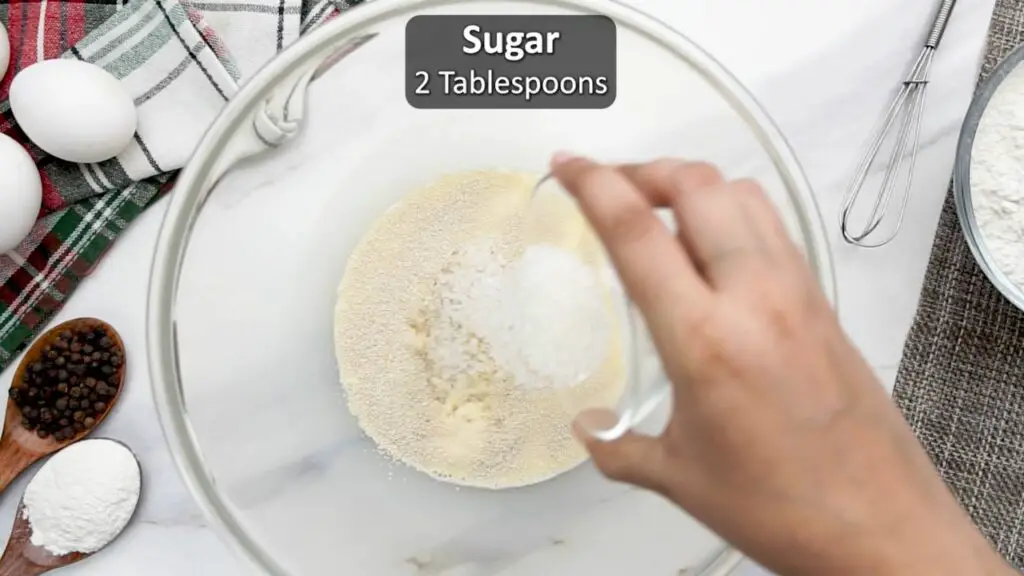adding the sugar to the dough