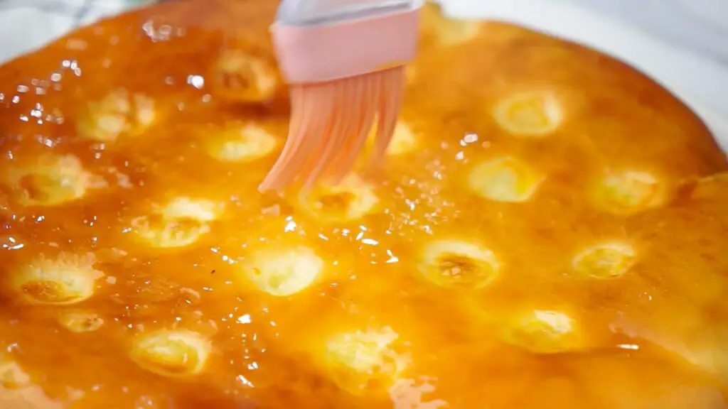 brushing the baked bread with melted butter