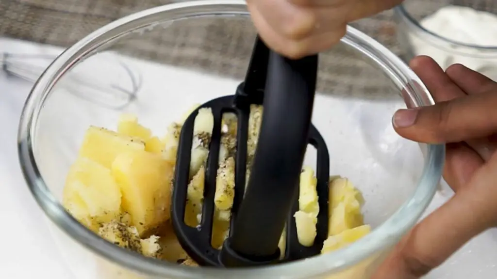 mashing potatoes for the bread filling 