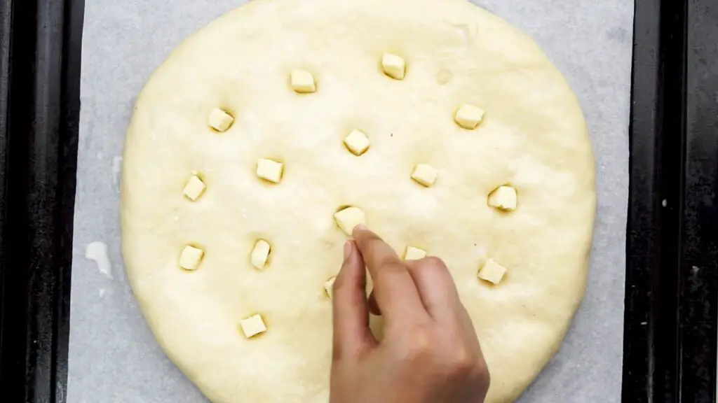 poking some holes in the bread dough and stuffing with a cheese